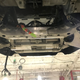 Fitting the rear axle assembly into the car.